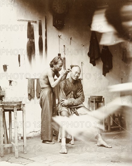 Ear cleaning at a barber's shop, China