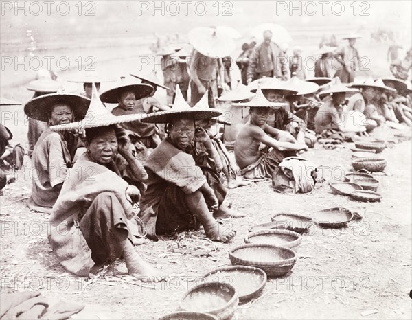 Mendicants beg by the roadside, China