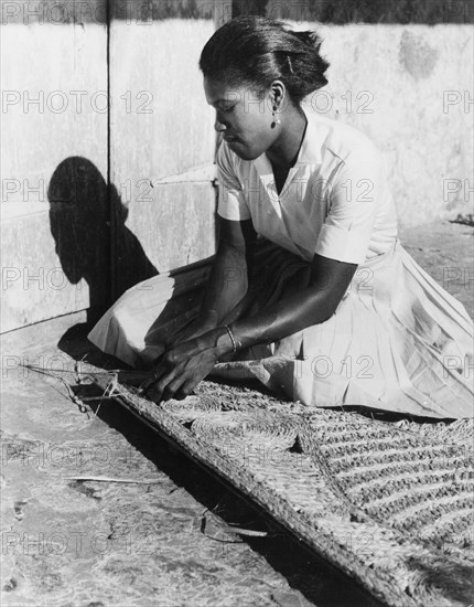 Weaving a palm mat, Dominica