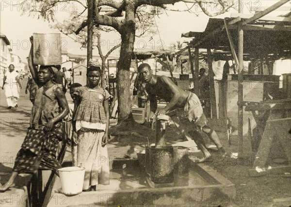 Collecting water from a hand pump, Accra