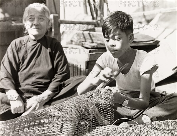 Repairing fishing nets in Hong Kong