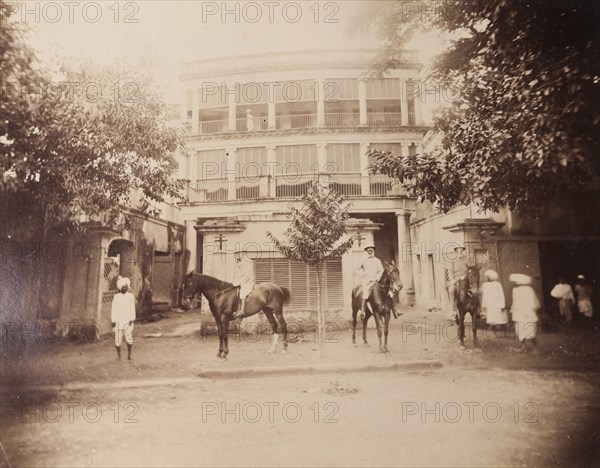 Saddling up outside a colonial house