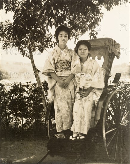 Geisha posing on a rickshaw