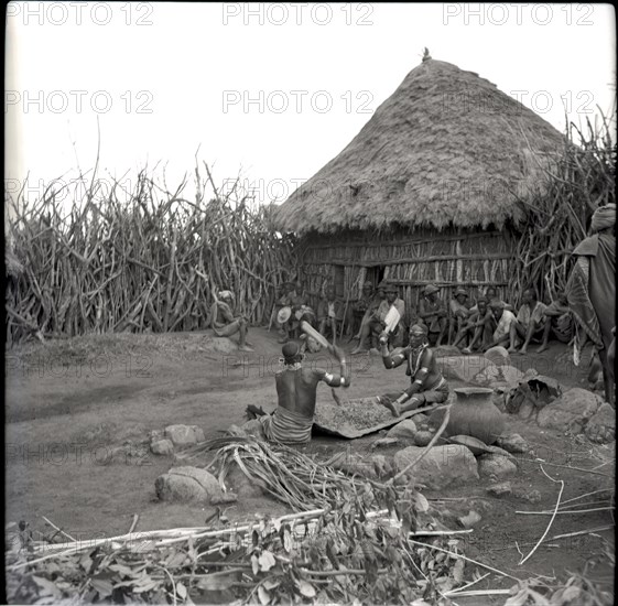 Women beating finger-millet