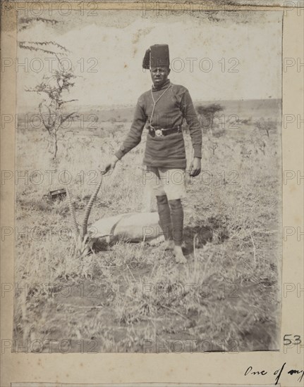 Uniformed servant with dead Thomson's gazelle