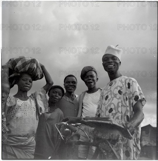 Ibadan: Town and market, group of men with bicycle