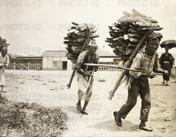 Korean labourers transporting firewood
