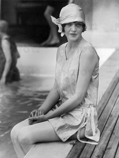 Young Woman Sitting By Pool