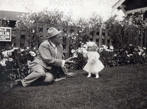 Man Talking To A Doll