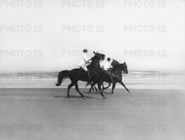 Riding Horses On The Beach