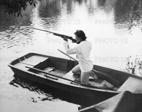 Woman Firing A Rifle