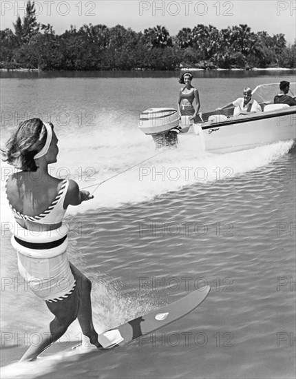 Young Woman Slalom Water Skis