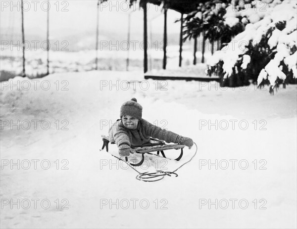 A Small Girl On A Sled