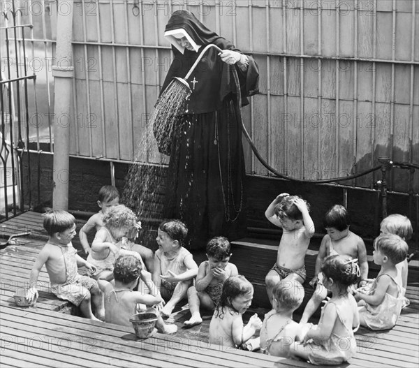 A Nun Watering Children