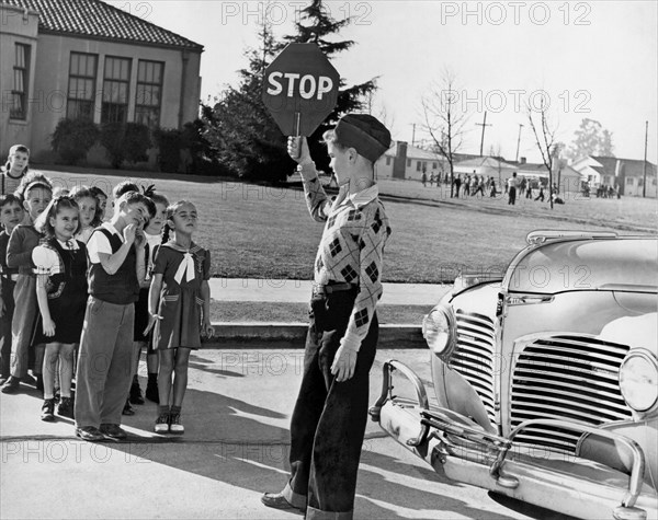 A Crossing Guard Holds Up Sign