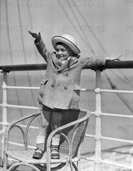 Boy Waving On Ocean Liner