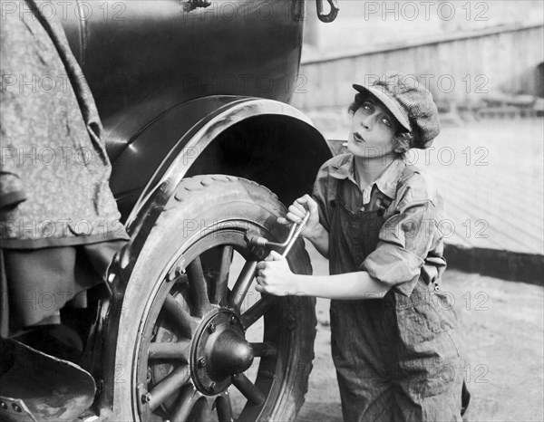 Actress Working On Her Car