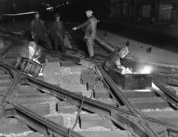 Railroad Workers Welding Track