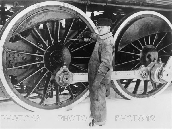 Engineer Greasing Train Wheels