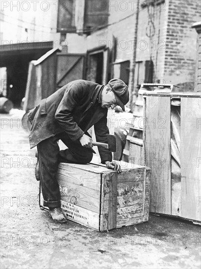 Worker Nailing Boxes