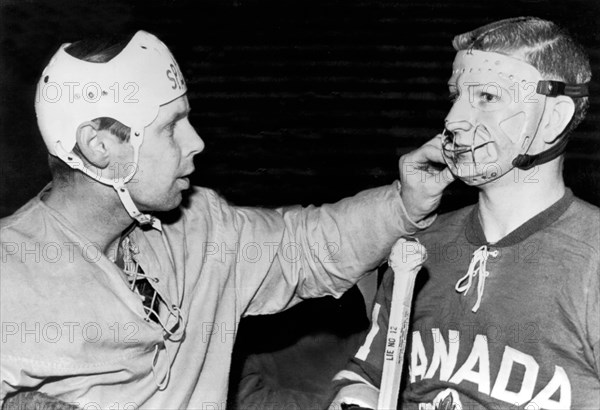 Hockey Goalie Inspects Mask