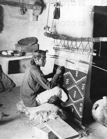 Navajo Man Weaving A Blanket