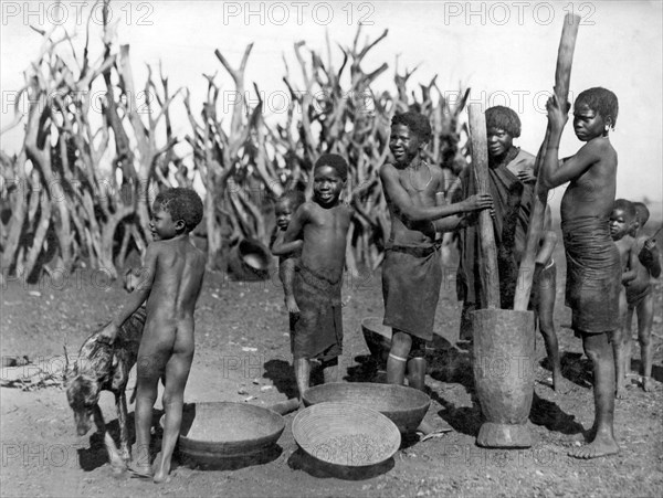 African Girls Grinding Corn