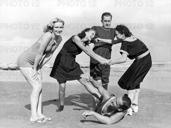 Two Women Tussle On The Beach