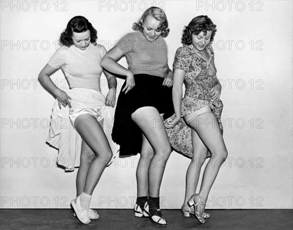 Three Women Lift Their Skirts