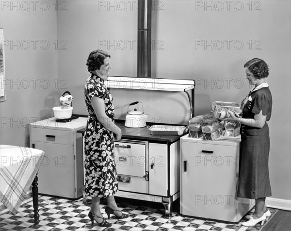 Beaver Dam, Wisconsin:  1937.
Two women admiring loaves of freshly baked bread.