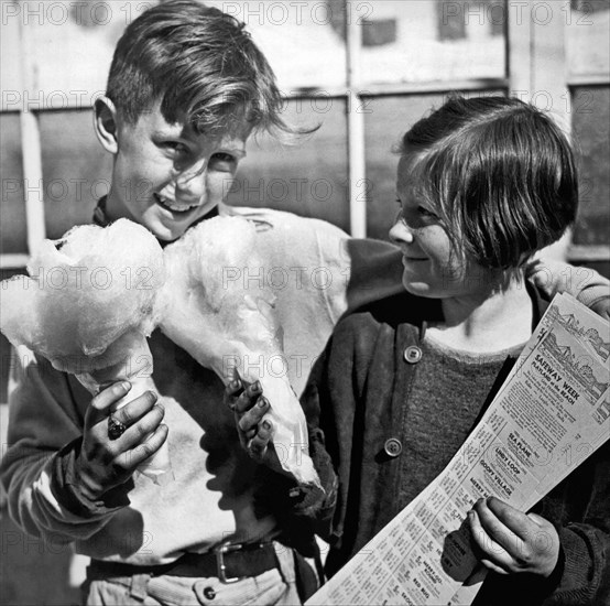 San Francisco, California:  March, 1937.
Two children eating cotton candy  take advantage of Safeway's Playland At The Beach Week coupons.