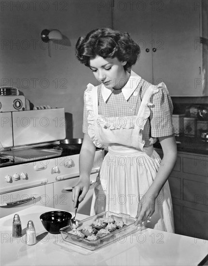 Hollywood, California:  1942.
Actress Marsha Hunt prepares summer squash in her kitchen. She was blacklisted during the 1940's and 50's for her First Amendment stands.