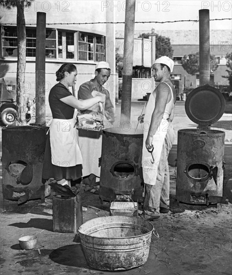 Rome, Italy:  August 23, 1947.
Cinecitta, the fabulous movie making center built by Mussolini, now serves as a refugee camp in post war Italy. Here the cooks in one of the outdoor kitchens prepare macaroni for the refugees.
