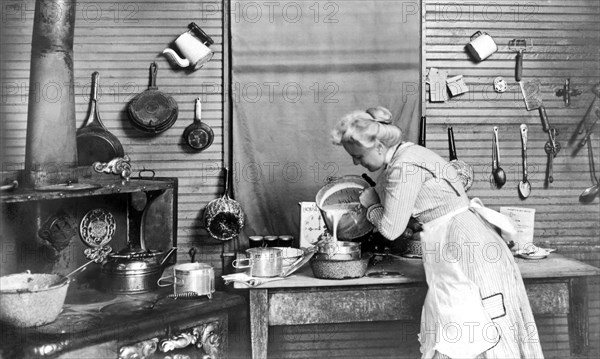 Crowley, Louisiana:   1910.
A woman pouring batter into a container.