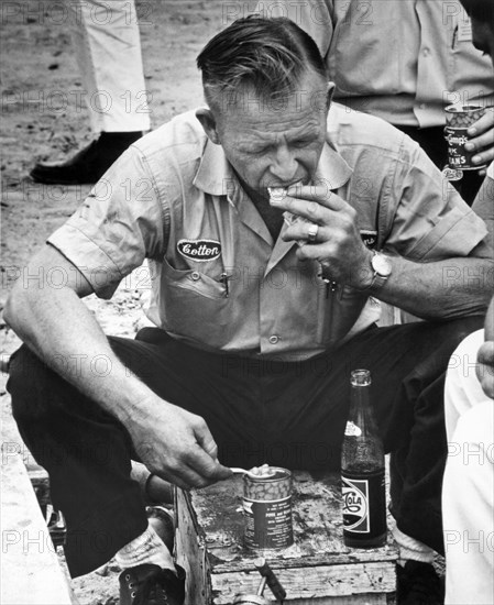 Spartanburg, South Carolina:  c. 1961.
Race car driver Cotton Owens refuels on canned pork & beans, crackers, and soda pop before the race starts.