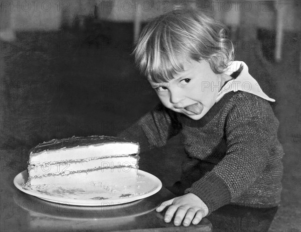 A Young Boy Ready For Cake