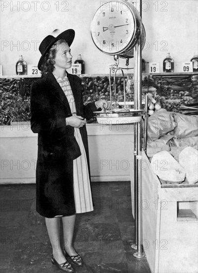 Woman Weighing Vegetables