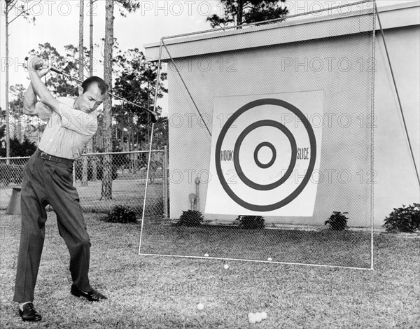 A Man Practices Golf