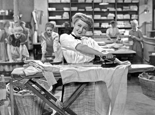 Woman Ironing In Laundry
