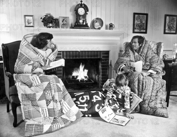 Family Huddled By Fireplace