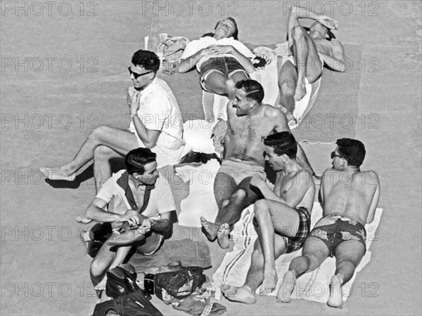 Group Of Men Sunbathing