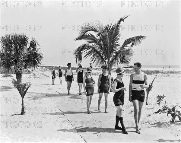 Couples strolling along the pathway on the beach.