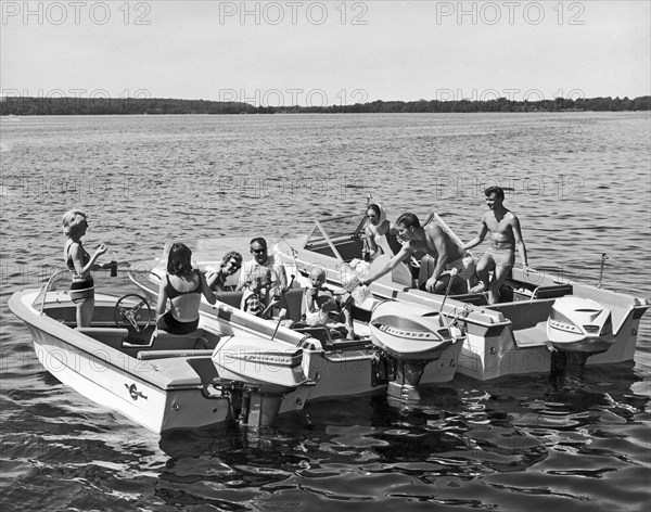 Three power boats gather together for summer boating fun