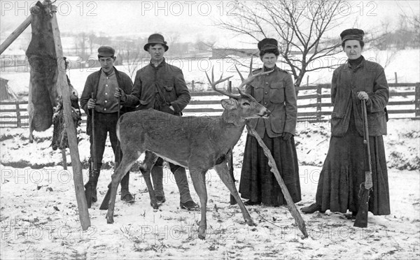 Four hunters and their game.