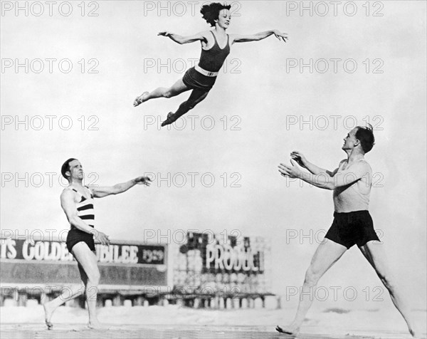 Beach Performers Toss Woman