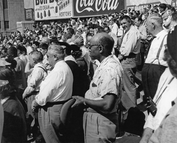 Fans at Yankee Stadium stand for the National Anthem at the star