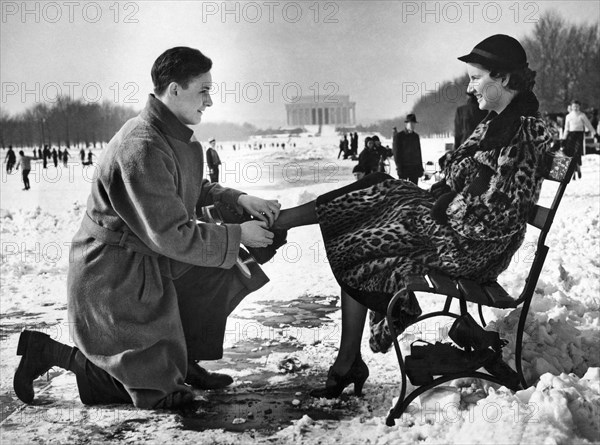 Man Lends A Helping Hand To Put On Skates