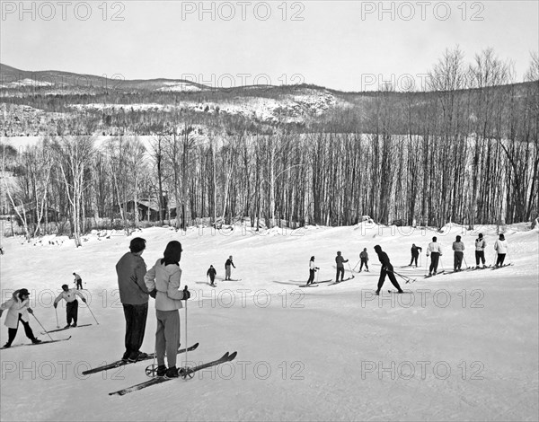 Two Skiers Pause On A Slope