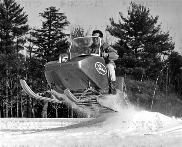 A Man Riding A Snowmobile