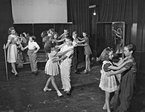 Young child actors in Hollywood learning folk dancing at their school.